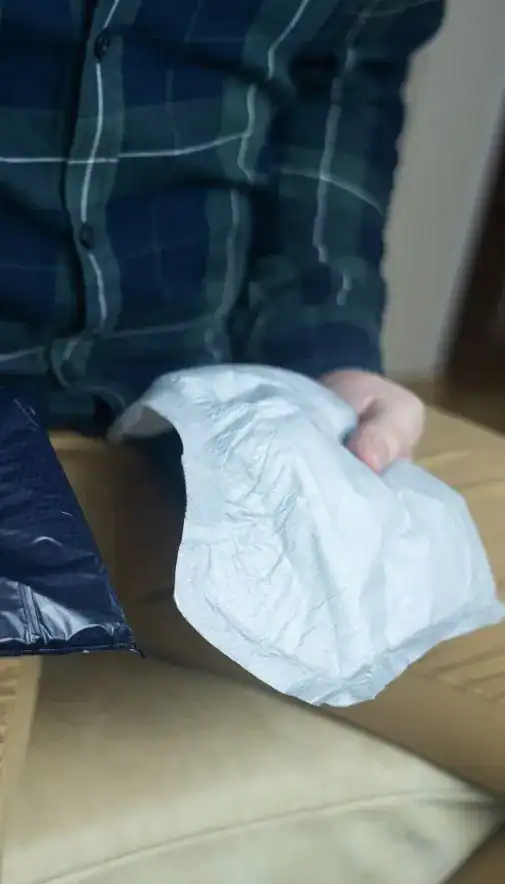 Image of man holding incontinence pads as part of overactive bladder treatment Leeds